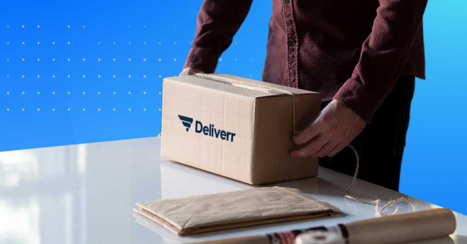 Person preparing box with Deliverr logo on the side, part of Deliverr Prep services